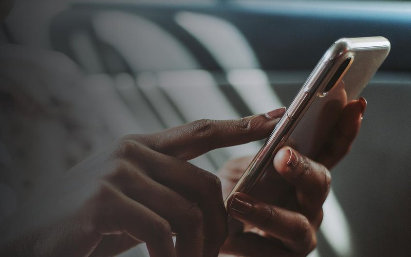 Hand holding a smartphone in low light